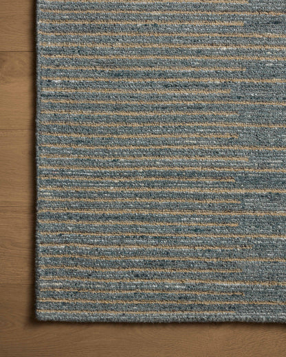 A hand-tufted wool area rug featuring graphic and high-low textured design and cool slate and warm natural tones, the Elias ELA-03 Slate / Natural Area Rug adds character to any room