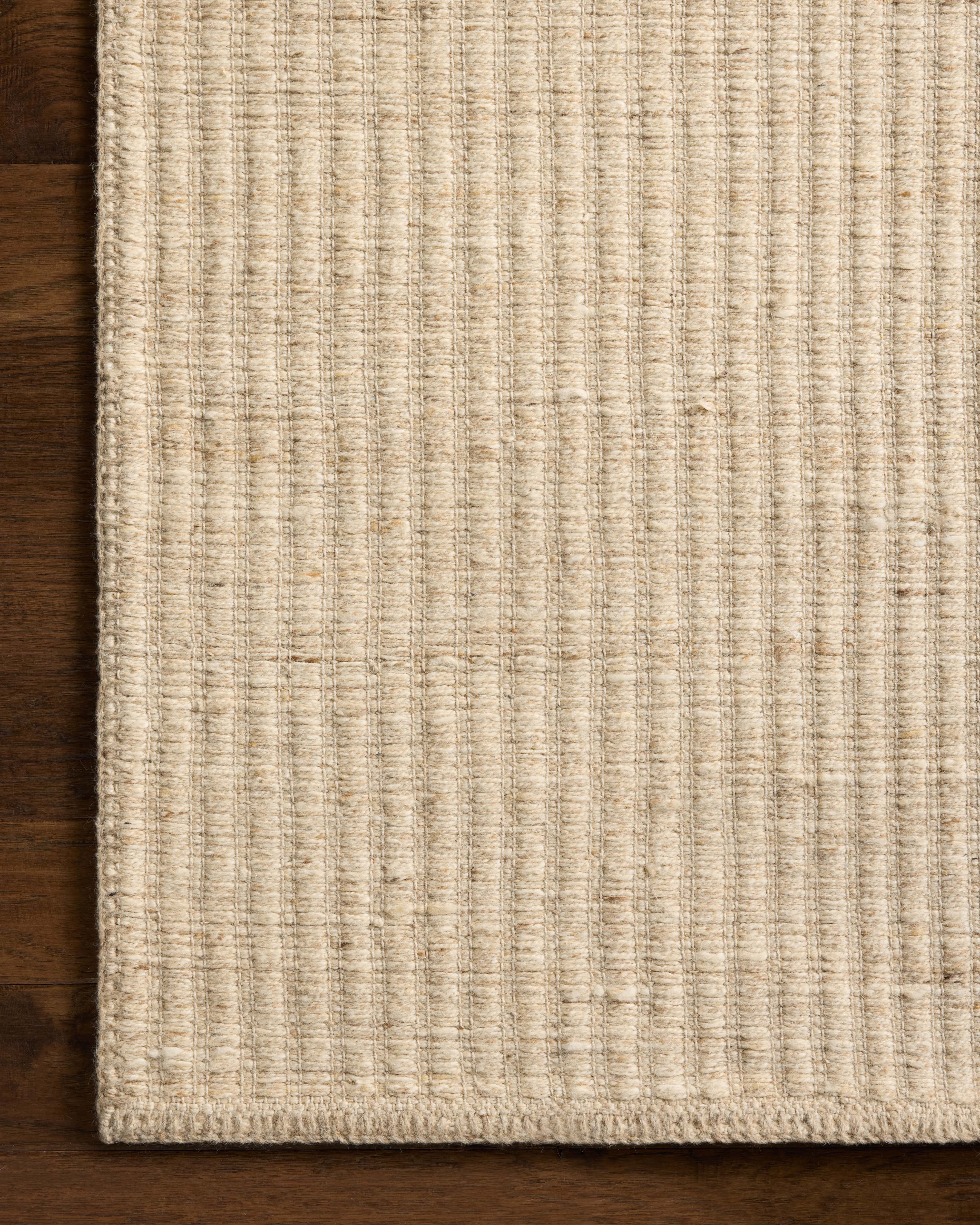 The Elma ELM-01 Bone Area Rug blends bone tones and striped motifs into a hand-woven wool and cotton area rug with timeless appeal
