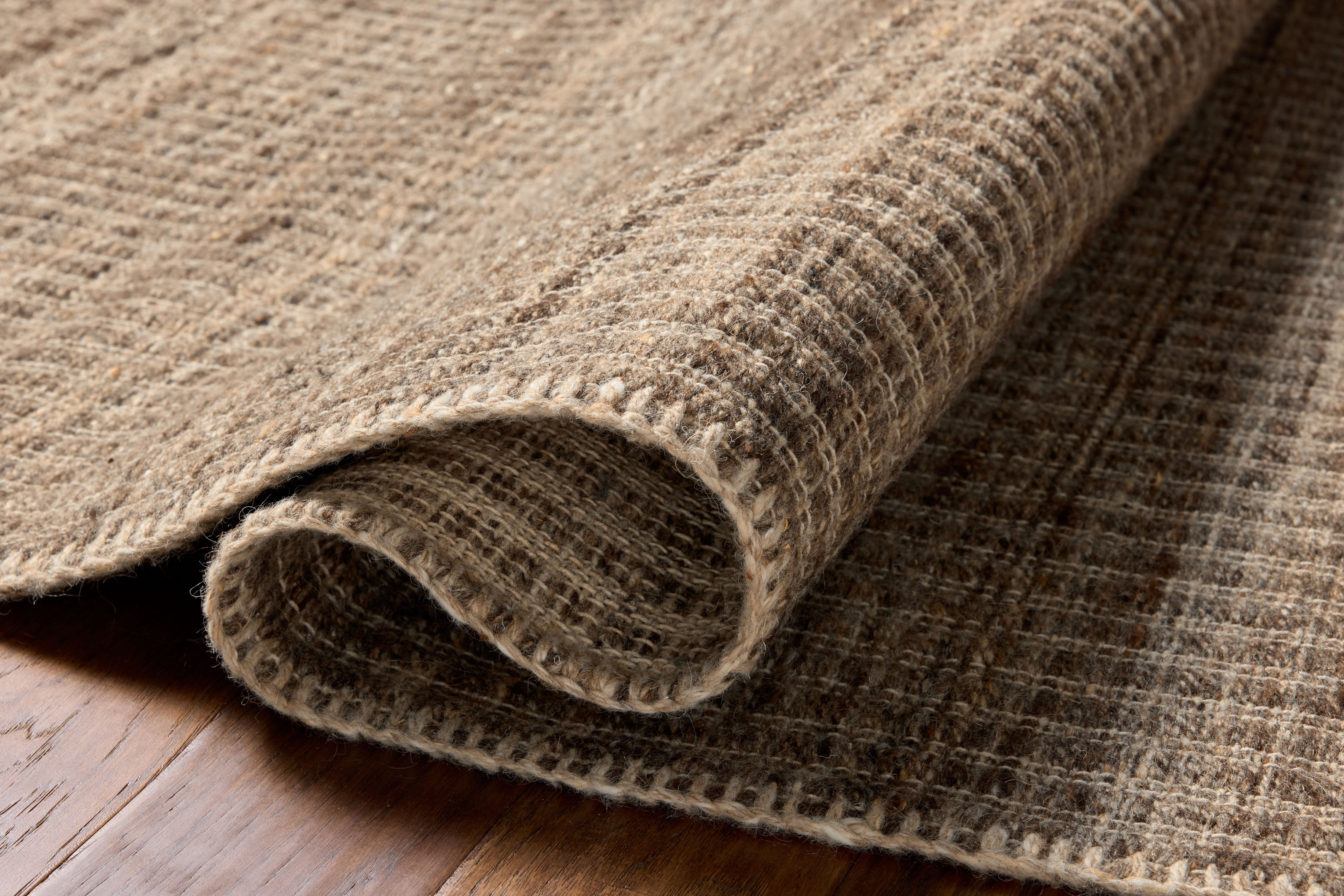 A stunning hand-woven wool and cotton area rug with striped detail, the Elma ELM-01 Bark Area Rug features grounded bark tones for a polished look