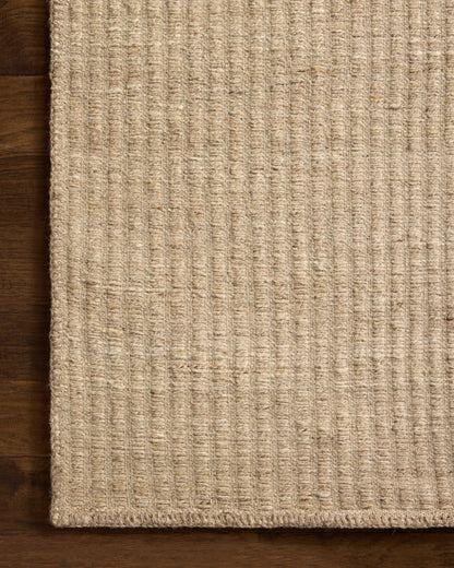 Designed with striped artistry in warm natural hues, the Elma ELM-01 Natural Area Rug is a hand-woven wool and cotton area rug that stands out