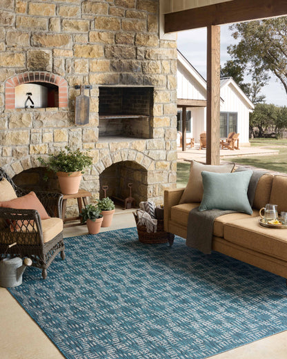 The Easton ESN-10 Fog / Teal Area Rug brings misty and vibrant teal character to your home in a power-loomed polypropylene area rug