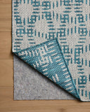 The Easton ESN-10 Fog / Teal Area Rug brings misty and vibrant teal character to your home in a power-loomed polypropylene area rug