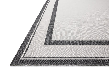 Finished in bold onyx and refined ivory tones, the Easton ESN-11 Onyx / Ivory Area Rug is a power-loomed polypropylene area rug for modern living