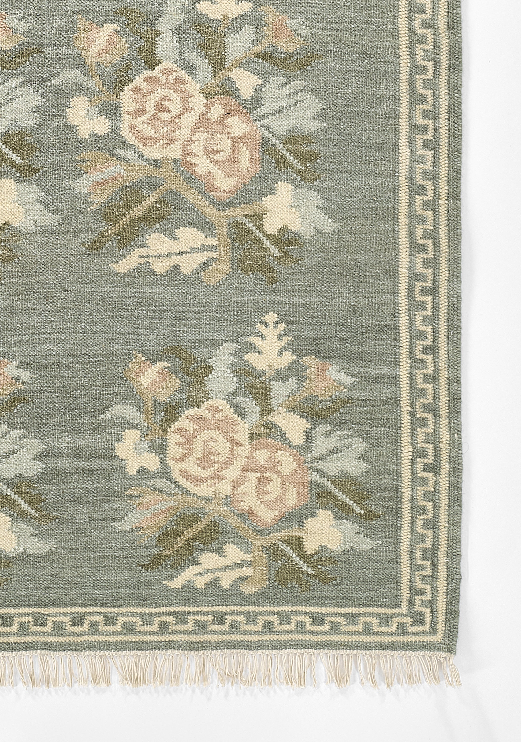 Momeni Florence FLO-1 Blue floral wool area rug with Bessarabian-inspired rose motifs, blush tones, decorative border, and fringed edges.