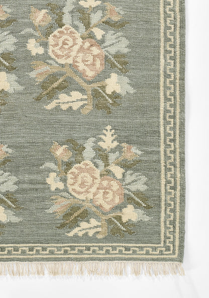 Momeni Florence FLO-1 Blue floral wool area rug with Bessarabian-inspired rose motifs, blush tones, decorative border, and fringed edges.