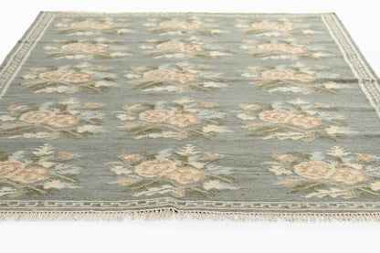 Momeni Florence FLO-1 Blue floral wool area rug with Bessarabian-inspired rose motifs, blush tones, decorative border, and fringed edges.