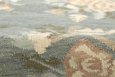 Momeni Florence FLO-1 Blue floral wool area rug with Bessarabian-inspired rose motifs, blush tones, decorative border, and fringed edges.