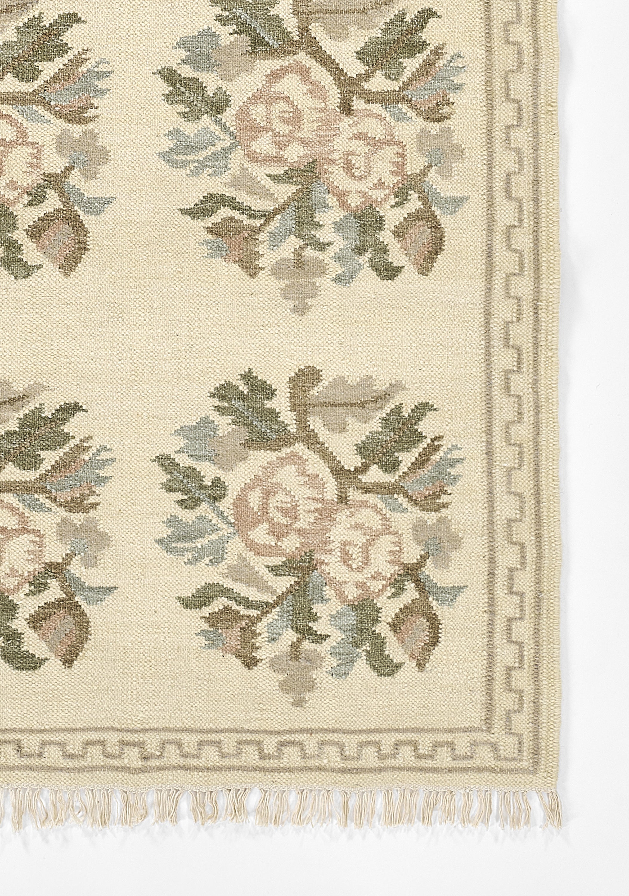 Momeni Florence FLO-1 ivory floral wool area rug with Bessarabian-style rose bouquet design, subtle blue and blush accents, ornamental border, and fringe.