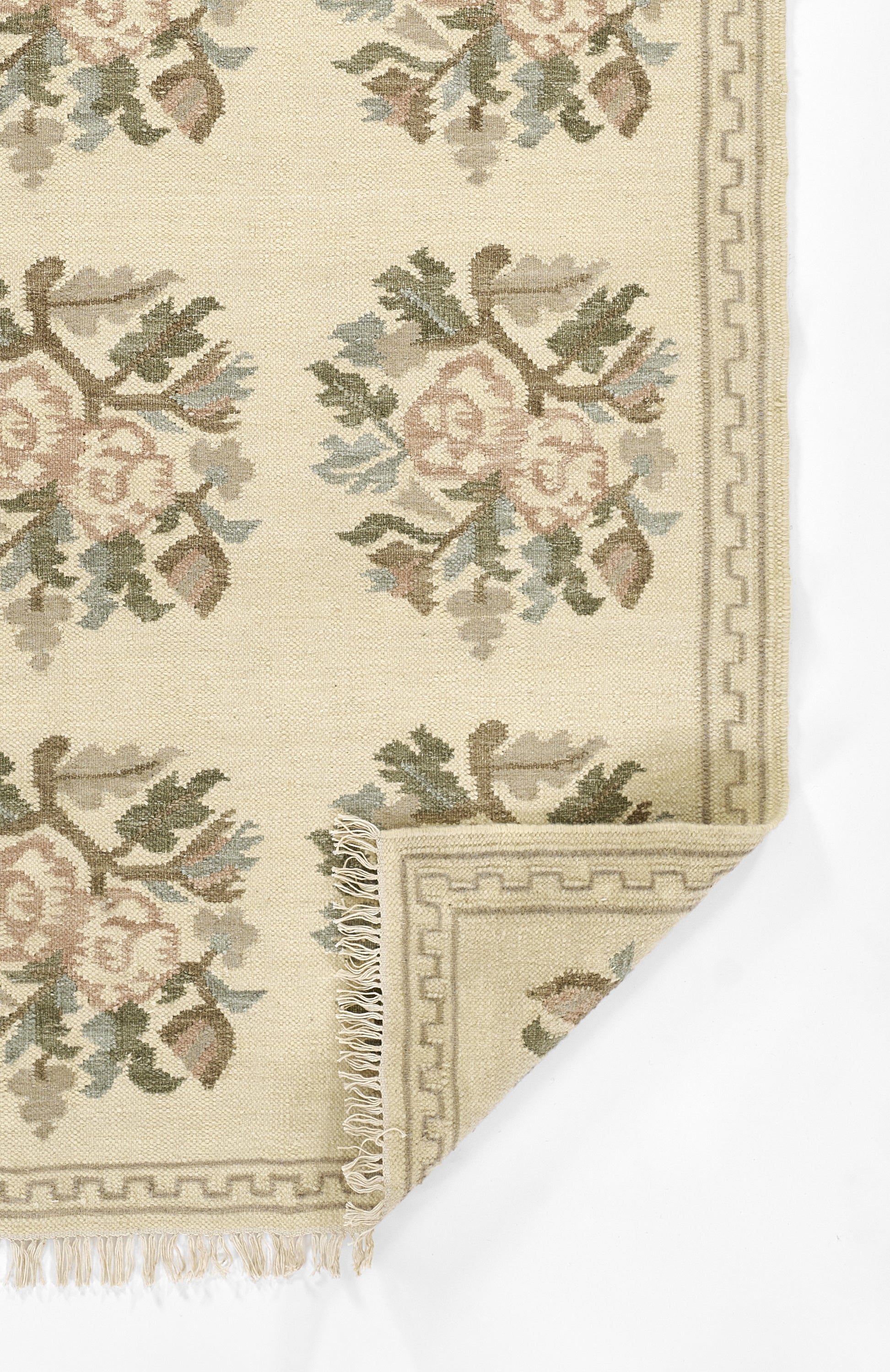 Momeni Florence FLO-1 ivory floral wool area rug with Bessarabian-style rose bouquet design, subtle blue and blush accents, ornamental border, and fringe.