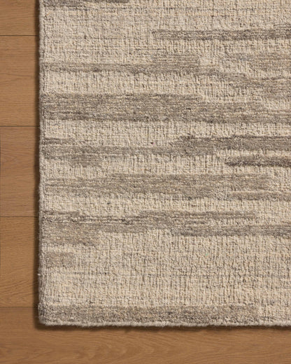 With shimmering silver and elegant grey hues and traditional styling, the Hartley HRT-02 Silver / Grey Area Rug is a hand-tufted wool area rug that elevates any room