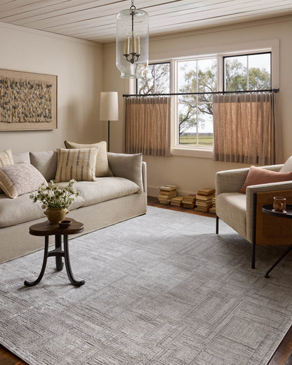 A power-loomed polyester area rug with geometric design in elegant grey and refined ivory hues, the Hollis HOL-01 Grey / Ivory Area Rug is a standout in any décor