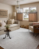 Dressed in refined ivory and grounding stone hues with geometric detail, the Hollis HOL-03 Ivory / Stone Area Rug is a power-loomed polyester area rug that completes any room