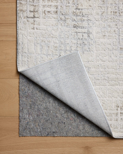 Dressed in refined ivory and grounding stone hues with geometric detail, the Hollis HOL-03 Ivory / Stone Area Rug is a power-loomed polyester area rug that completes any room