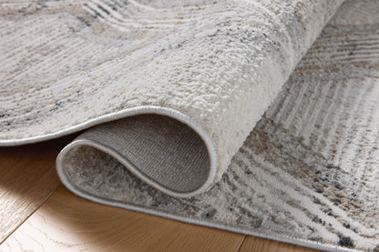 A power-loomed polyester area rug in soft misty and warm natural tones with geometric motifs, the Hollis HOL-05 Mist / Natural Area Rug grounds your room beautifully