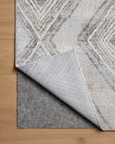 A power-loomed polyester area rug in soft misty and warm natural tones with geometric motifs, the Hollis HOL-05 Mist / Natural Area Rug grounds your room beautifully
