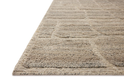 Dressed in gentle dove hues with graphic detail, the Hughes HUS-01 Dove Area Rug is a hand-knotted wool area rug that completes any room