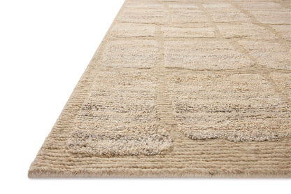 The Hughes HUS-01 Natural Area Rug transforms any space with warm natural tones and graphic design in a hand-knotted wool area rug