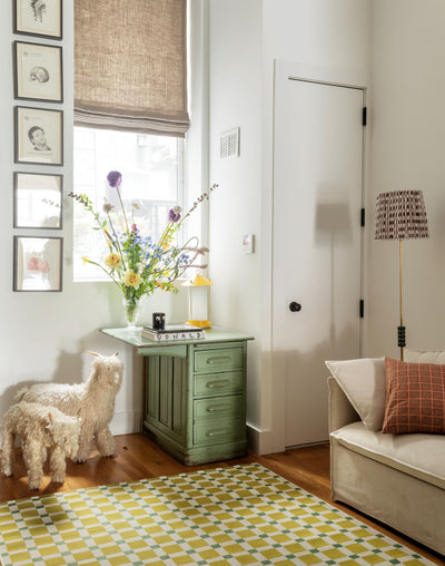 Icon ICN-1 Green Area Rug in a sunlit living room with a yellow-green checkered pattern.