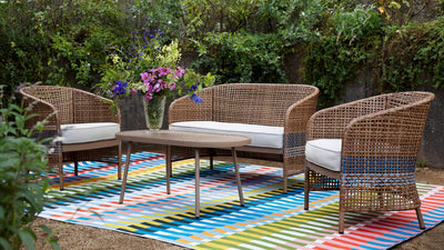 Icon ICN-2 Multicolor Area Rug with striped Mid-Century Modern flair under outdoor wicker chairs.