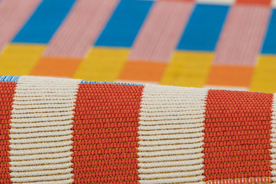 Icon ICN-2 Multicolor Area Rug: close-up of red-and-white woven pattern with bold multicolor background.