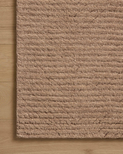 Finished in delicate blush tones with ribbed styling, the Kai KAI-01 Blush Area Rug is a hand-tufted wool area rug for modern living