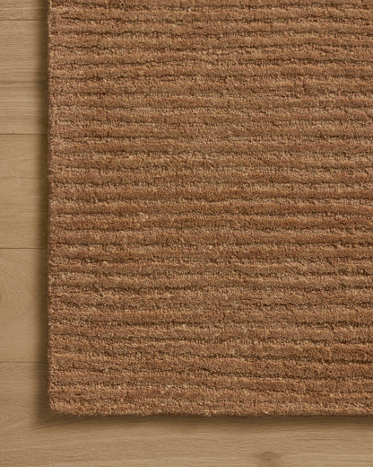 Dressed in rich terracotta hues with ribbed detail, the Kai KAI-01 Terracotta Area Rug is a hand-tufted wool area rug that completes any room