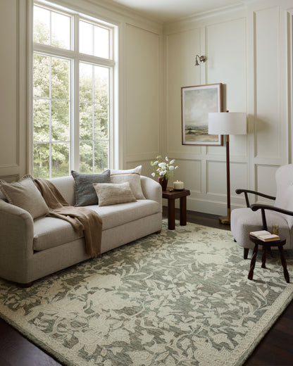 The Lenore LNO-02 Lagoon / Wheat Area Rug blends tranquil lagoon and golden wheat tones and floral motifs into a hand-tufted wool area rug with timeless appeal