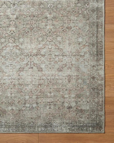 Overhead view of the Amelia JYAL-2300 Blush Area Rug with a faded vintage pattern on wood flooring.