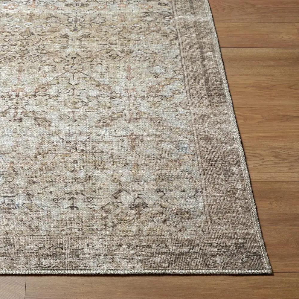 Close-up of the Amelia JYAL-2301 Ivory Area Rug featuring a faded vintage pattern on wood flooring.