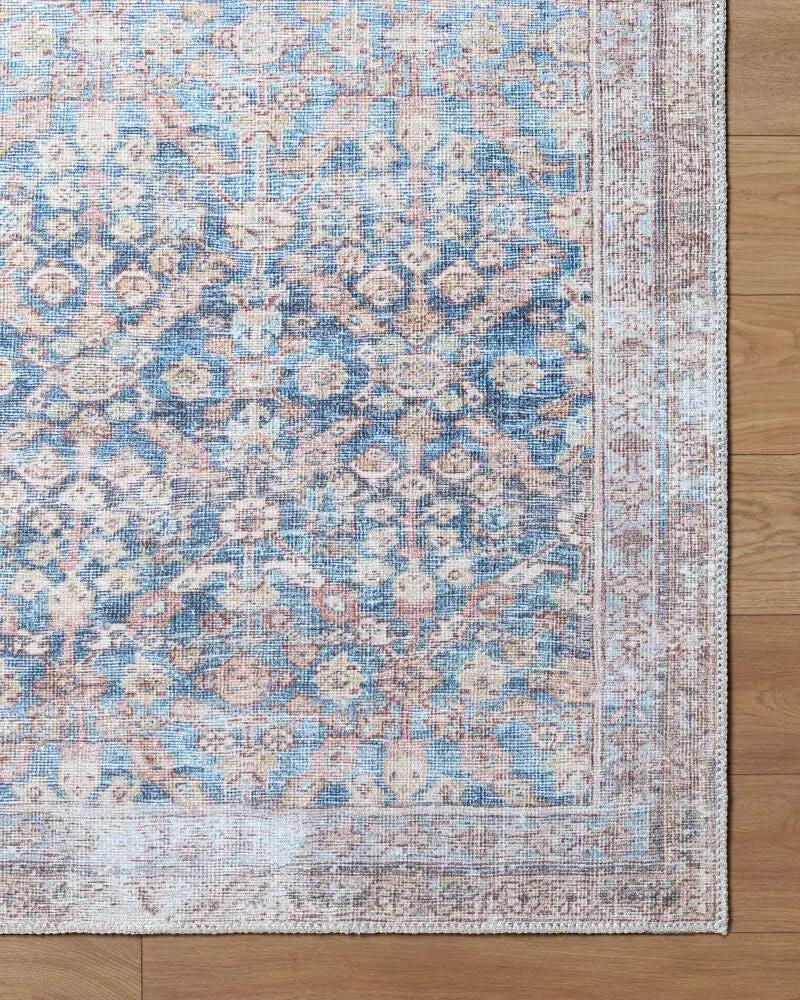 Amelia JYAL-2302 Slate Blue Area Rug with a distressed vintage pattern on a wood floor.