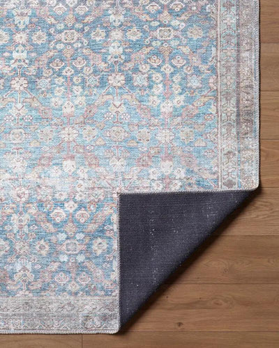 Close-up of the Amelia Sky Blue Area Rug showing its intricate pattern and dark non-slip backing.