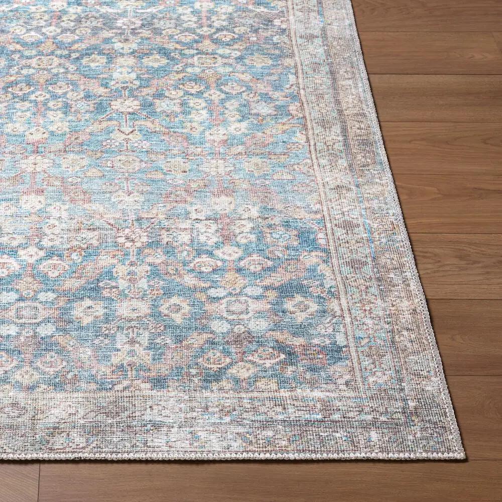 Amelia JYAL-2303 Sky Blue Area Rug with a distressed vintage pattern on a wood floor.