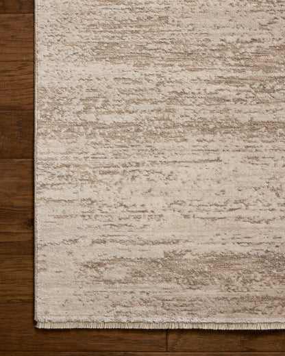 The Nellie NEL-04 Ivory / Pebble Area Rug blends refined ivory and subtle pebble tones and graphic motifs into a power-loomed polyester and polypropylene area rug with timeless appeal