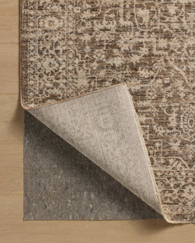 The Newman NEW-02 Dark Taupe / Natural Area Rug is a power-loomed polyester area rug that radiates dark taupe and warm natural charm and vintage and distressed elegance