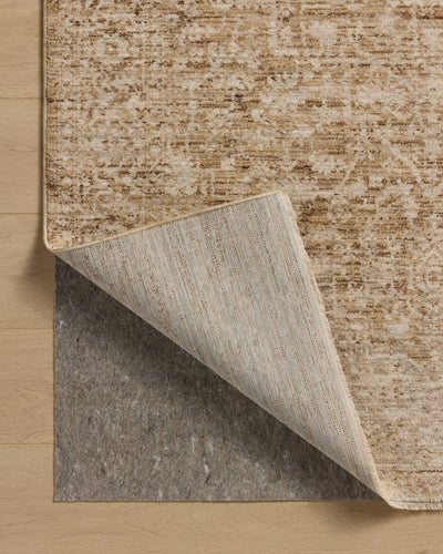 Layered in golden wheat and warm natural hues with vintage and distressed patterns, the Newman NEW-02 Wheat / Natural Area Rug is a power-loomed polyester area rug perfect for any setting