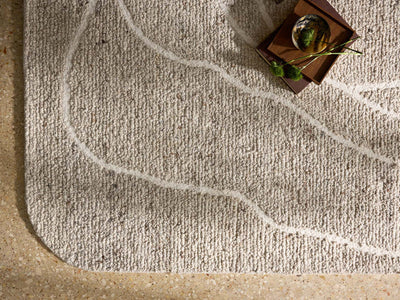 The Otis OTT-01 Oatmeal / Ivory Area Rug pairs cozy oatmeal and refined ivory tones and linear patterns in a hand-tufted wool area rug