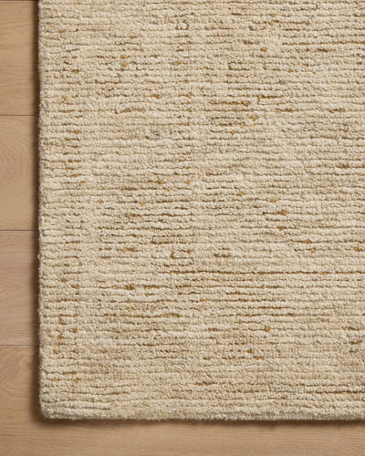 The Penny PEN-01 Gold / Natural Area Rug is a hand-tufted wool area rug that radiates radiant gold and warm natural charm and ribbed and high-low textured elegance