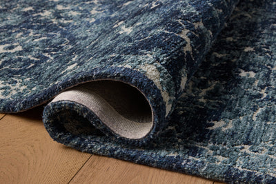 Dressed in classic navy and refined ivory hues with traditional detail, the Percival PCV-02 Navy / Ivory Area Rug is a power-loomed polyester area rug that completes any room