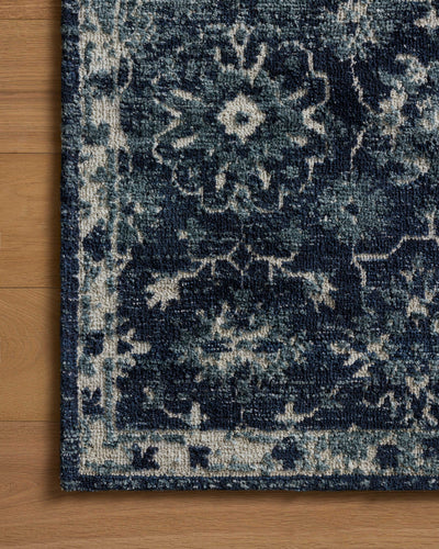 Dressed in classic navy and refined ivory hues with traditional detail, the Percival PCV-02 Navy / Ivory Area Rug is a power-loomed polyester area rug that completes any room