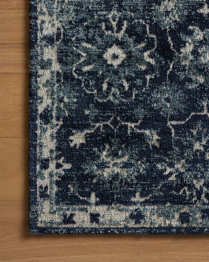 Dressed in classic navy and refined ivory hues with traditional detail, the Percival PCV-02 Navy / Ivory Area Rug is a power-loomed polyester area rug that completes any room