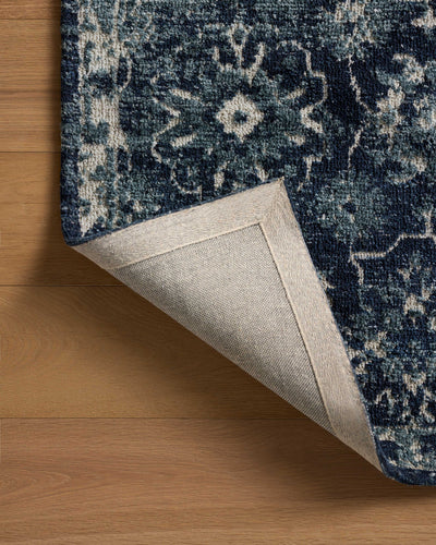 Dressed in classic navy and refined ivory hues with traditional detail, the Percival PCV-02 Navy / Ivory Area Rug is a power-loomed polyester area rug that completes any room
