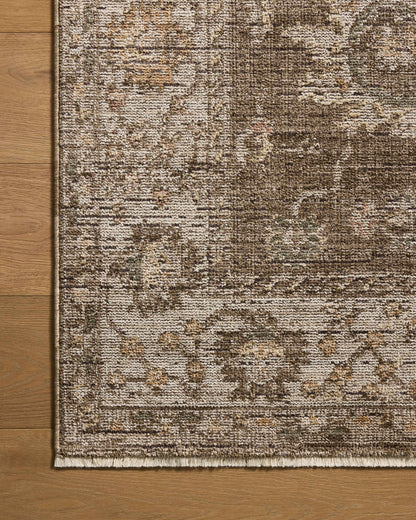 Layered in grounded bark and refined ivory hues with vintage patterns, the Priscilla PRL-01 Bark / Ivory Area Rug is a power-loomed 100% polyester area rug perfect for any setting