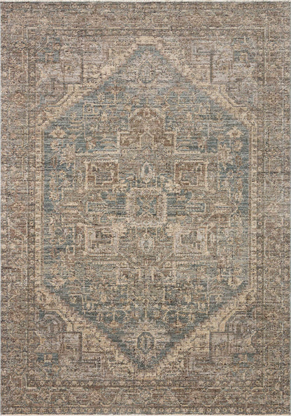 A power-loomed 100% polyester area rug with vintage flair in calming blue and grounded bark tones, the Priscilla PRL-04 Blue / Bark Area Rug anchors any room