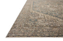 A power-loomed 100% polyester area rug with vintage flair in calming blue and grounded bark tones, the Priscilla PRL-04 Blue / Bark Area Rug anchors any room
