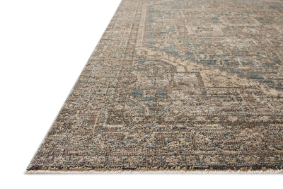 A power-loomed 100% polyester area rug with vintage flair in calming blue and grounded bark tones, the Priscilla PRL-04 Blue / Bark Area Rug anchors any room