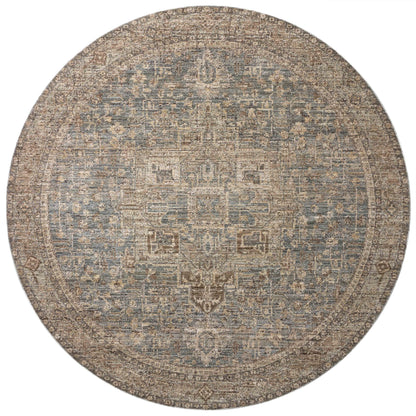 A power-loomed 100% polyester area rug with vintage flair in calming blue and grounded bark tones, the Priscilla PRL-04 Blue / Bark Area Rug anchors any room