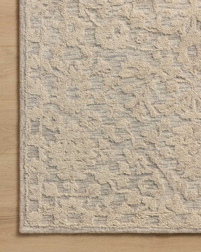 A hand-tufted wool and cotton area rug with floral flair in soft misty and refined ivory tones, the Prudence PRU-01 Mist / Ivory Area Rug anchors any room