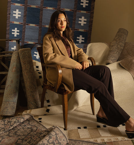 Patricia Rodi designer rug collection featuring rich geometric patterns, vintage-inspired rugs, and warm earthy tones of navy, beige, brown, and rust, blending artistic character with timeless sophistication for stylish interiors.