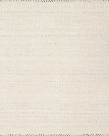 The Sloane SLN-01 Sky Area Rug pairs breezy sky-blue tones and bohemian and contemporary patterns in a hand-woven wool, cotton, and polyester area rug