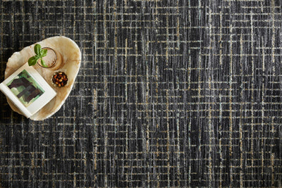 With bold onyx and shimmering silver hues and contemporary and abstract styling, the Soho SOH-01 Onyx / Silver Area Rug is a power-loomed 100% polyester area rug that elevates any room